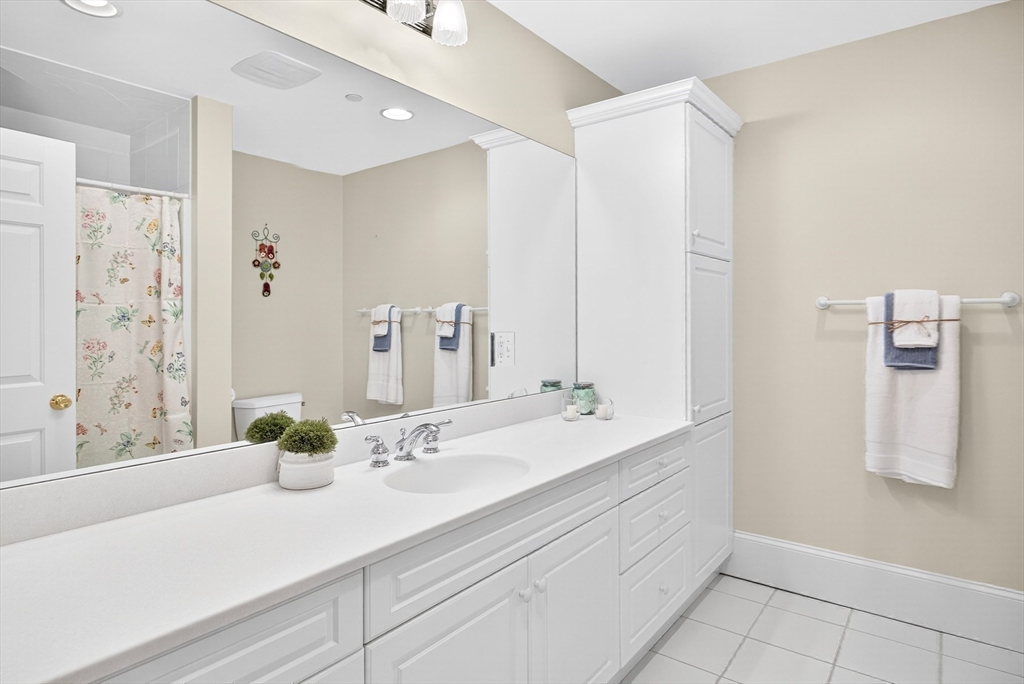 199 East Bay Road, Unit 13 Barnstable, MA 02655 - Photo 28 of 40 a bathroom with a sink and a mirror