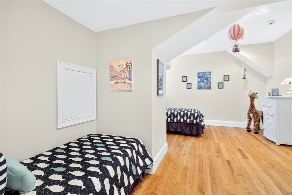 199 East Bay Road, Unit 13 Barnstable, MA 02655 - Photo 29 of 40 a bedroom with a bed and wooden floor