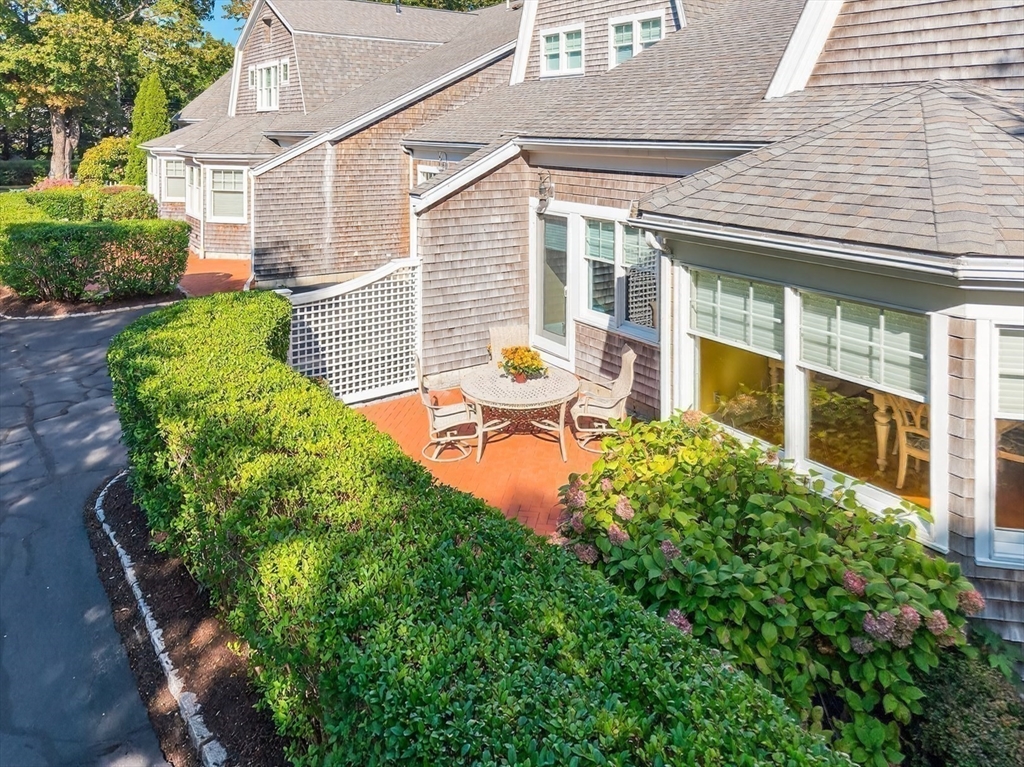 199 East Bay Road, Unit 13 Barnstable, MA 02655 - Photo 30 of 40 a front view of a house with patio