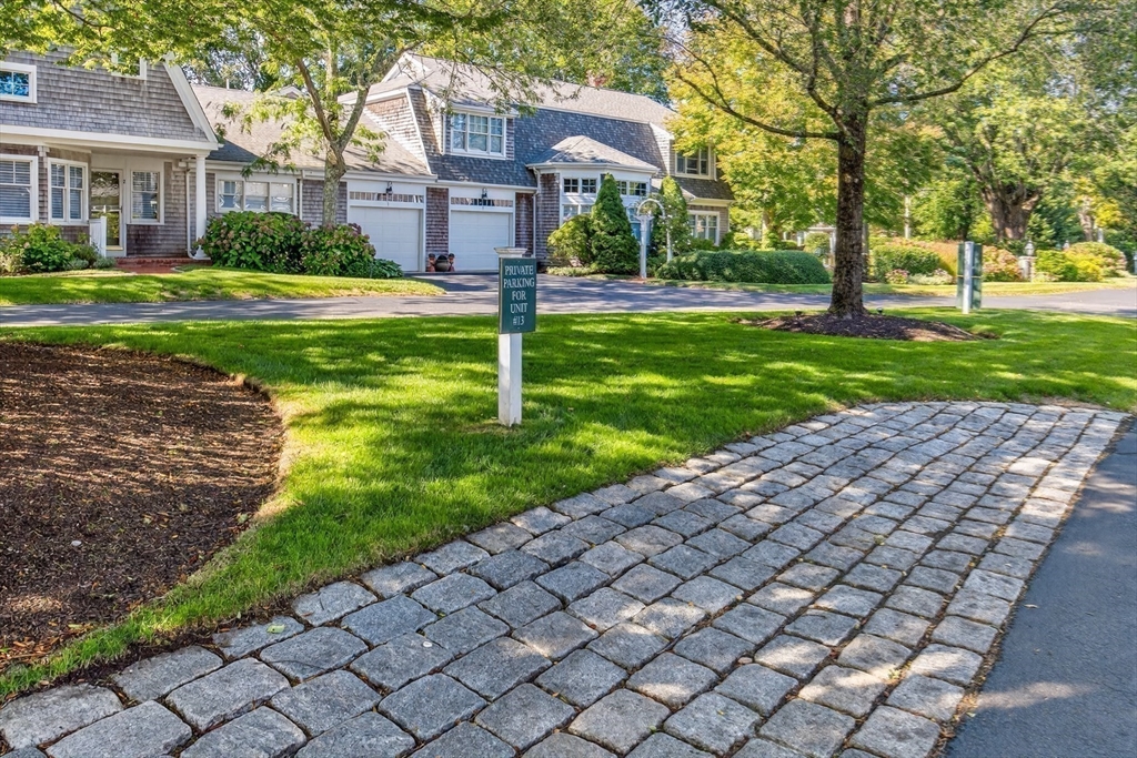 199 East Bay Road, Unit 13 Barnstable, MA 02655 - Photo 32 of 40 a front view of a house with a yard
