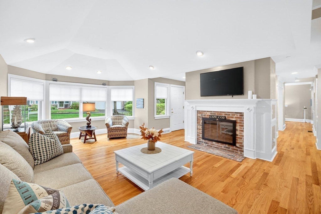 199 East Bay Road, Unit 13 Barnstable, MA 02655 - Photo 9 of 40 a living room with furniture fireplace and a flat screen tv