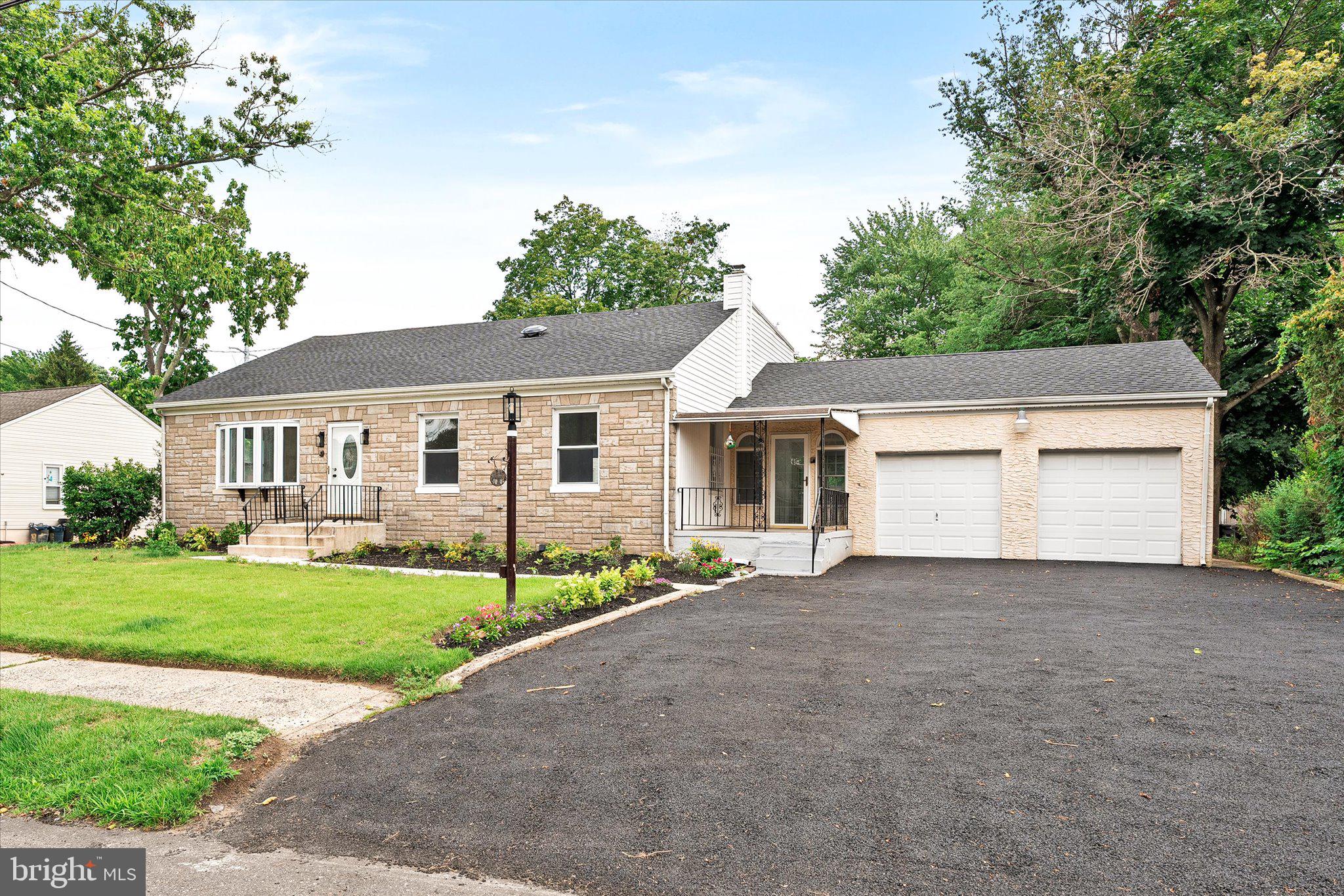 a view of a house with a yard and garage