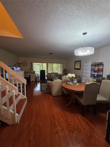 a living room with furniture fireplace and wooden floor