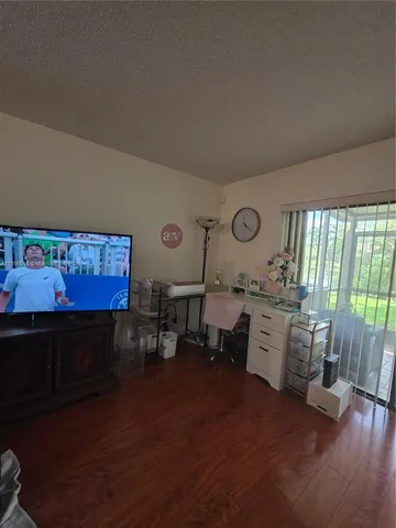 a view of workspace with furniture and wooden floor