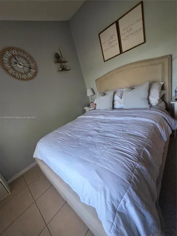 a bedroom with a bed and wall painting