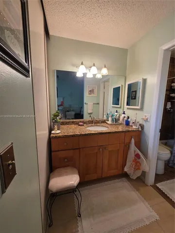 a bathroom with a toilet and a shower curtain