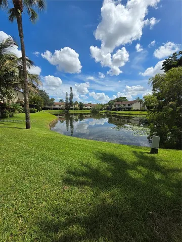 a view of a backyard with table and chairs and a yard