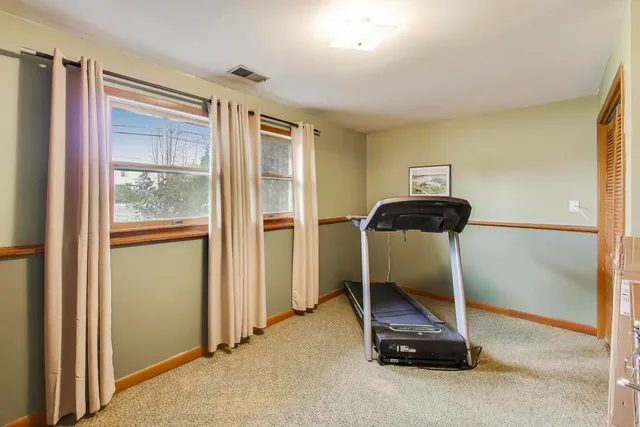 a room with gym equipment and a large window