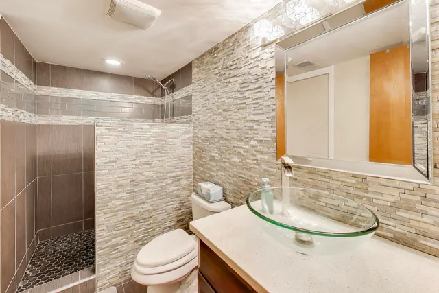 a bathroom with a sink toilet and shower