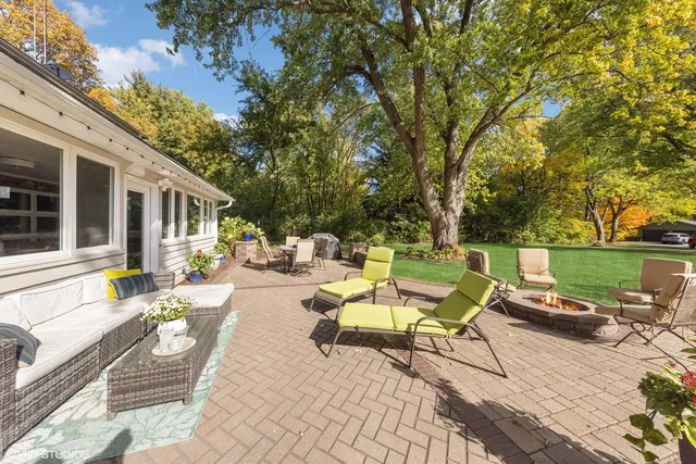 a view of a patio with chairs and tables on the patio