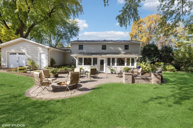 a view of a patio with table and chairs under an umbrella