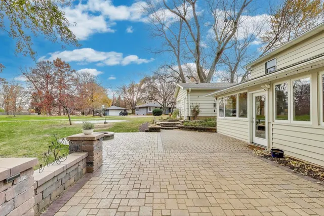 a view of a house with backyard and a garden