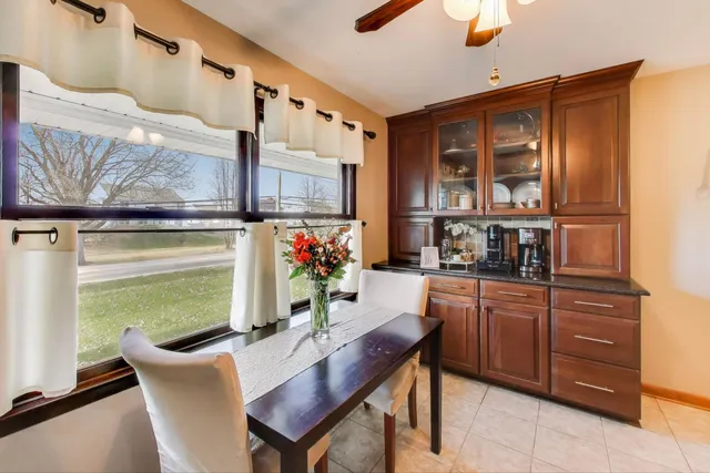 a dining room with furniture and a window