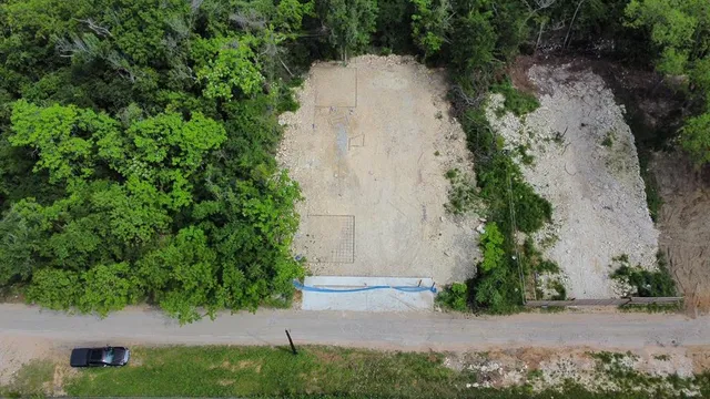 an aerial view of a house with a yard and a outdoor seating