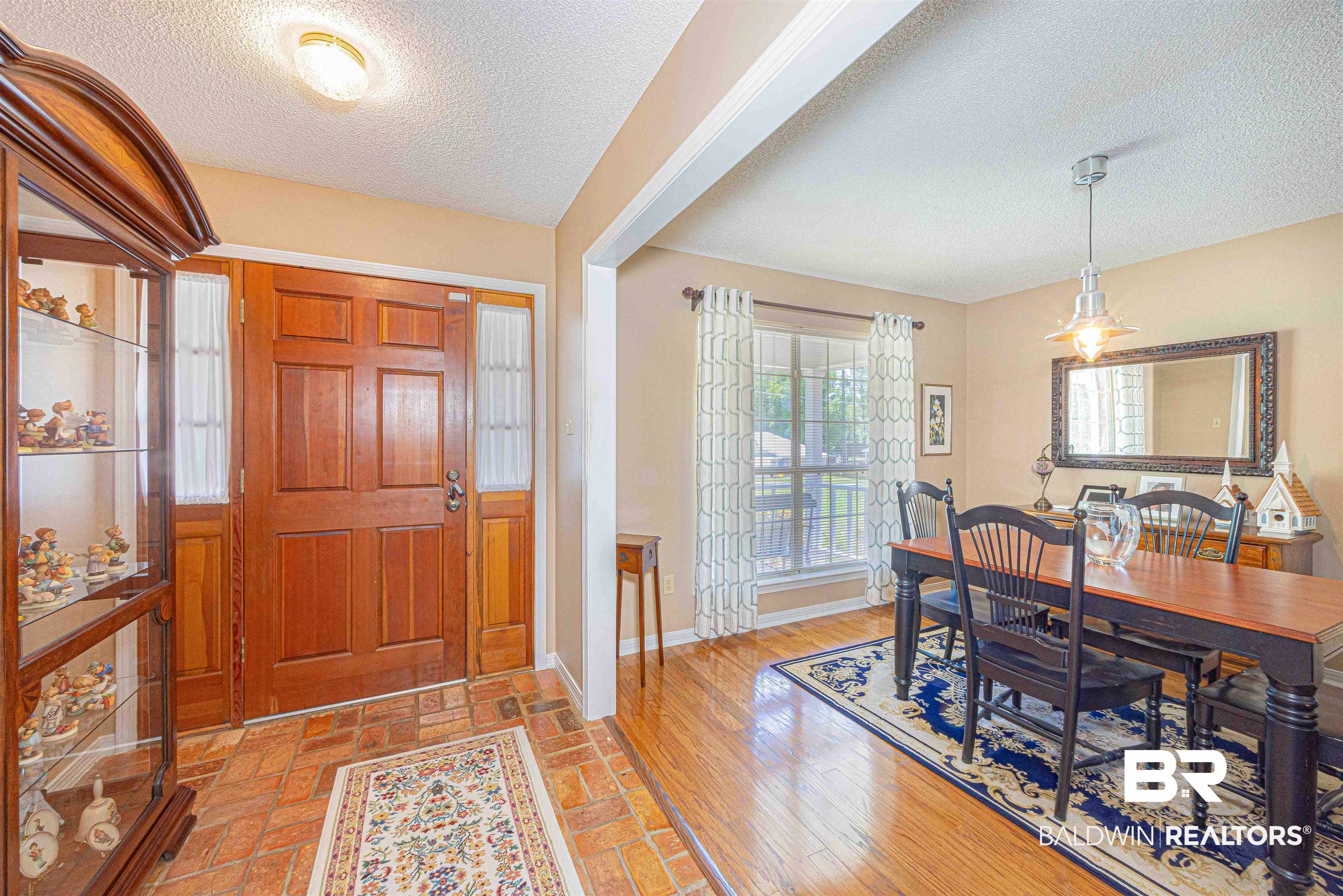 485 Ridgewood Drive Daphne, AL 36526 - Photo 7 of 38 Foyer entrance featuring baseboards and a textured ceiling