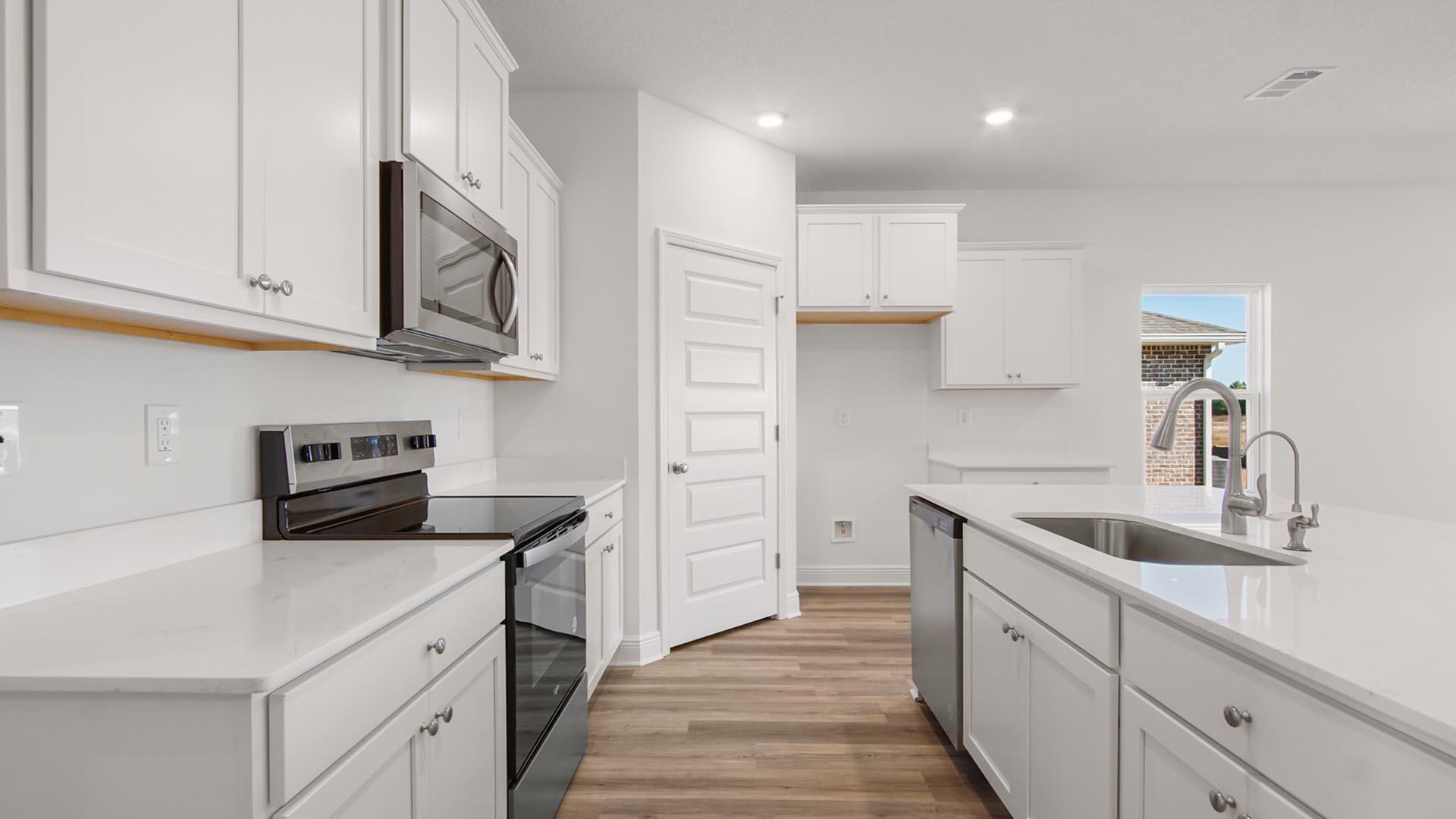 50 Foxtrail Run Freeport, FL 32439 - Photo 6 of 17 a kitchen with cabinets stainless steel appliances a sink and a refrigerator