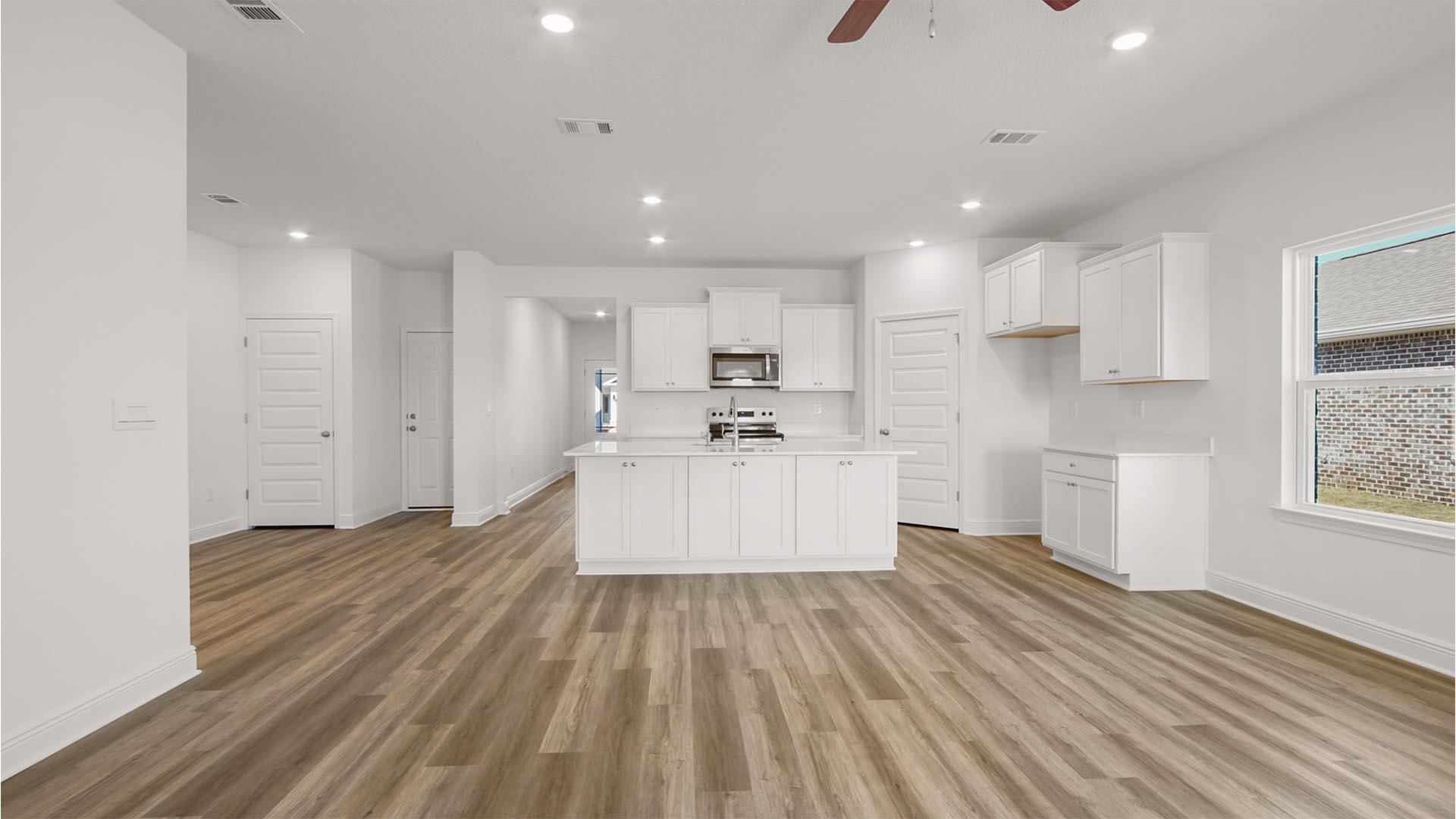 50 Foxtrail Run Freeport, FL 32439 - Photo 8 of 17 a large white kitchen with kitchen island a sink a center island stainless steel appliances and a counter top space