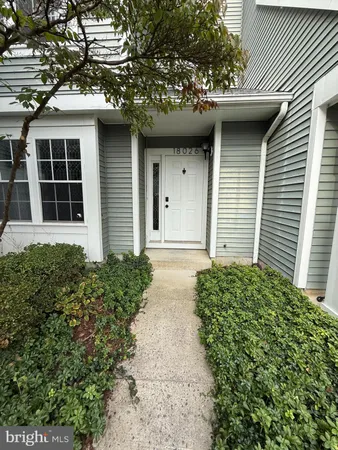 a view of a house with a small yard and plants