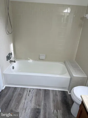 a bathroom with a bathtub and a toilet