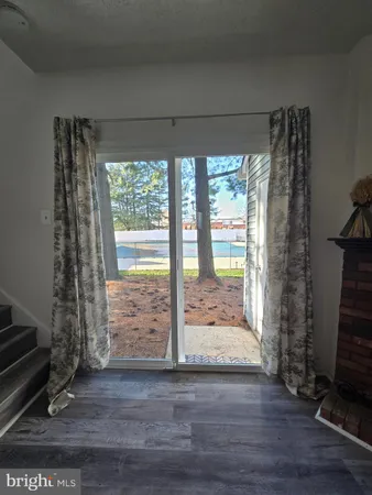 a view of front door and porch with wooden floor