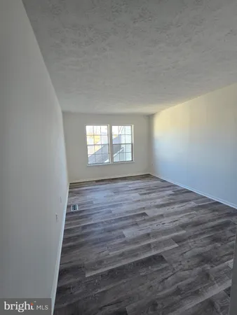 a view of wooden floor and windows in a room