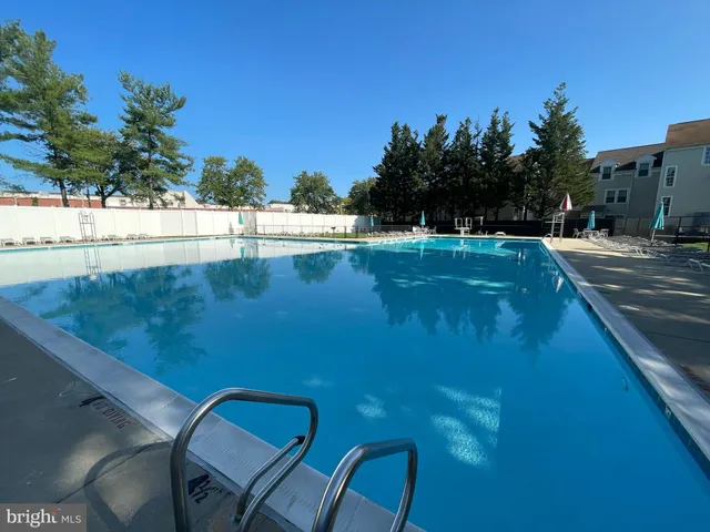 a view of a swimming pool with an outdoor seating