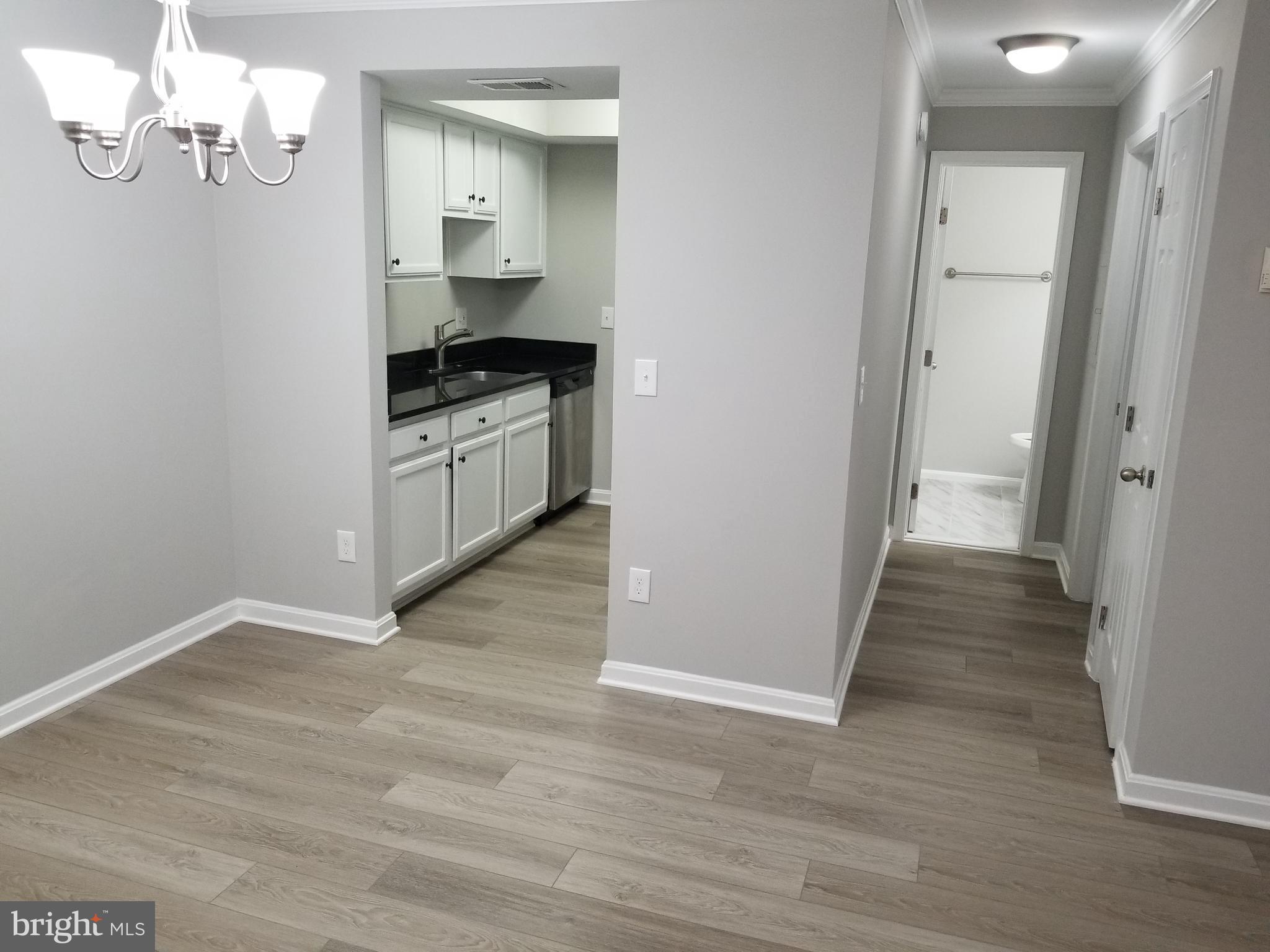 14905 Rydell Road, Unit 204 Centreville, VA 20121 - Photo 4 of 18 Dining/Living Room.1 - Kitchen and Hallway