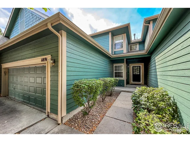 a backyard of a house with plants and entryway