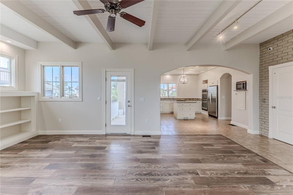 3073 Gulf Winds Circle Hernando Beach, FL 34607 - Photo 12 of 95 a view of a livingroom with wooden floor and a ceiling fan
