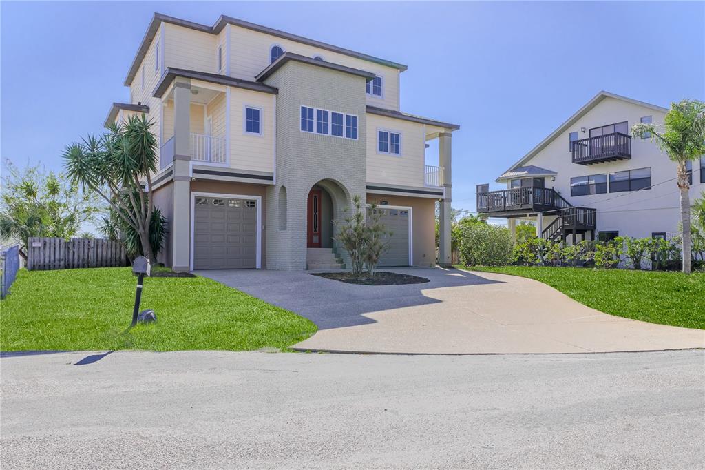 3073 Gulf Winds Circle Hernando Beach, FL 34607 - Photo 5 of 95 a front view of a house with a garden and garage