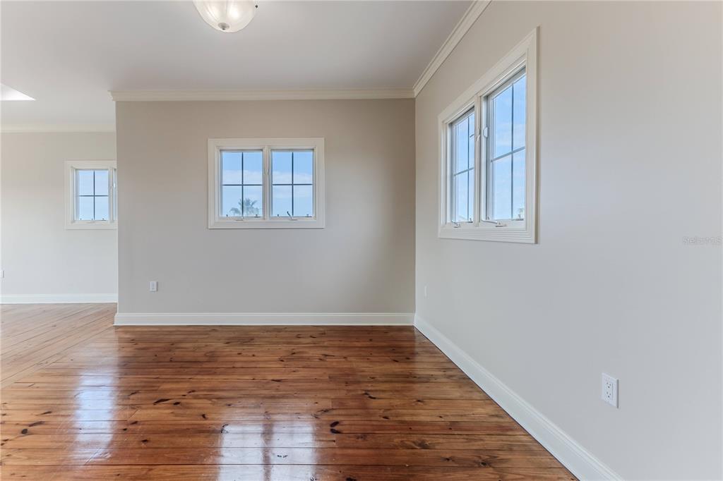 3073 Gulf Winds Circle Hernando Beach, FL 34607 - Photo 51 of 95 an empty room with wooden floor and windows