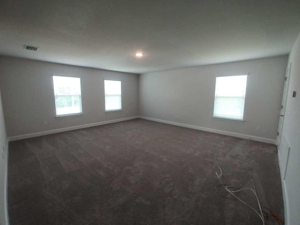 4380 Southwest 92nd Pl Road Ocala, FL 34476 - Photo 33 of 57 an empty room with windows