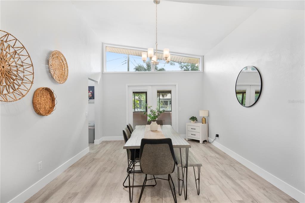 2214 Nottingham Road Lakeland, FL 33803 - Photo 15 of 40 a view of a dining room with furniture a chandelier and wooden floor