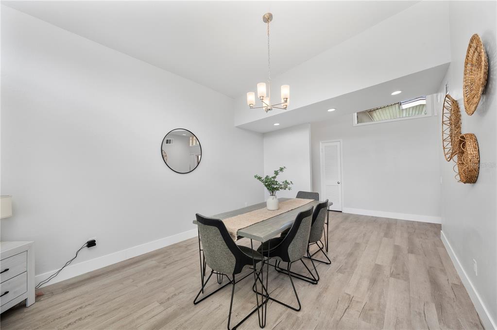 2214 Nottingham Road Lakeland, FL 33803 - Photo 16 of 40 a view of a dining room with furniture and chandelier