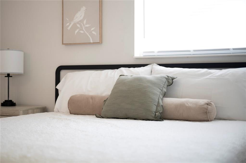 2214 Nottingham Road Lakeland, FL 33803 - Photo 19 of 40 a bedroom with a bed and a night stand