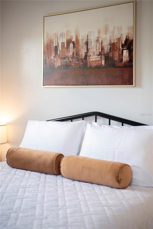 2214 Nottingham Road Lakeland, FL 33803 - Photo 25 of 40 a bed sitting in a bedroom and painting on the wall