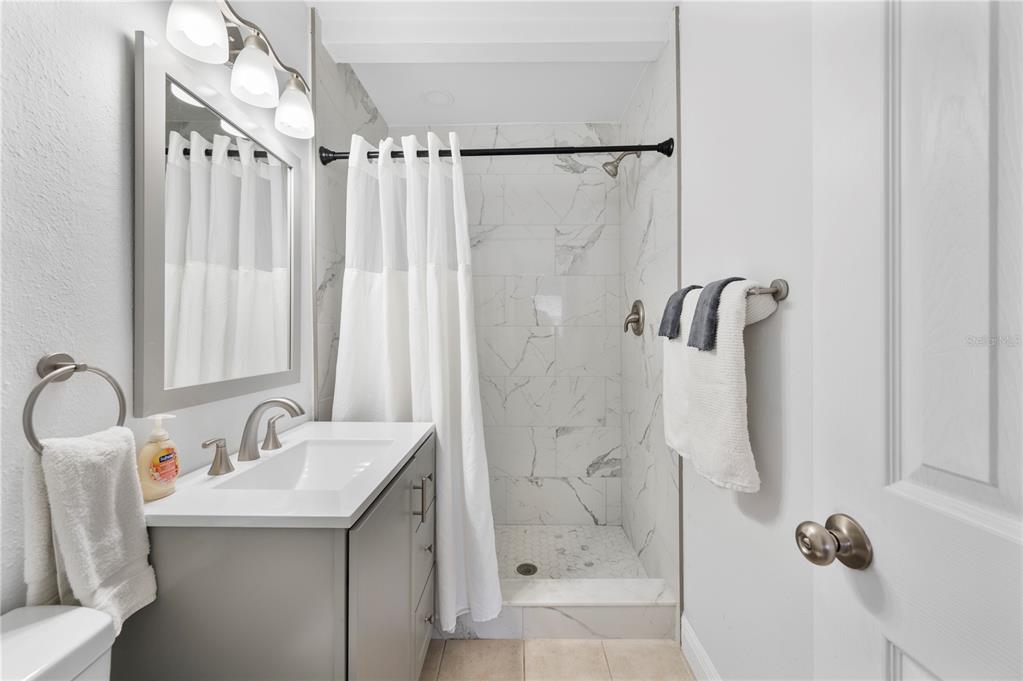 2214 Nottingham Road Lakeland, FL 33803 - Photo 30 of 40 a bathroom with a sink mirror and shower