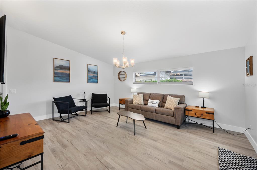 2214 Nottingham Road Lakeland, FL 33803 - Photo 3 of 40 a living room with furniture and a chandelier