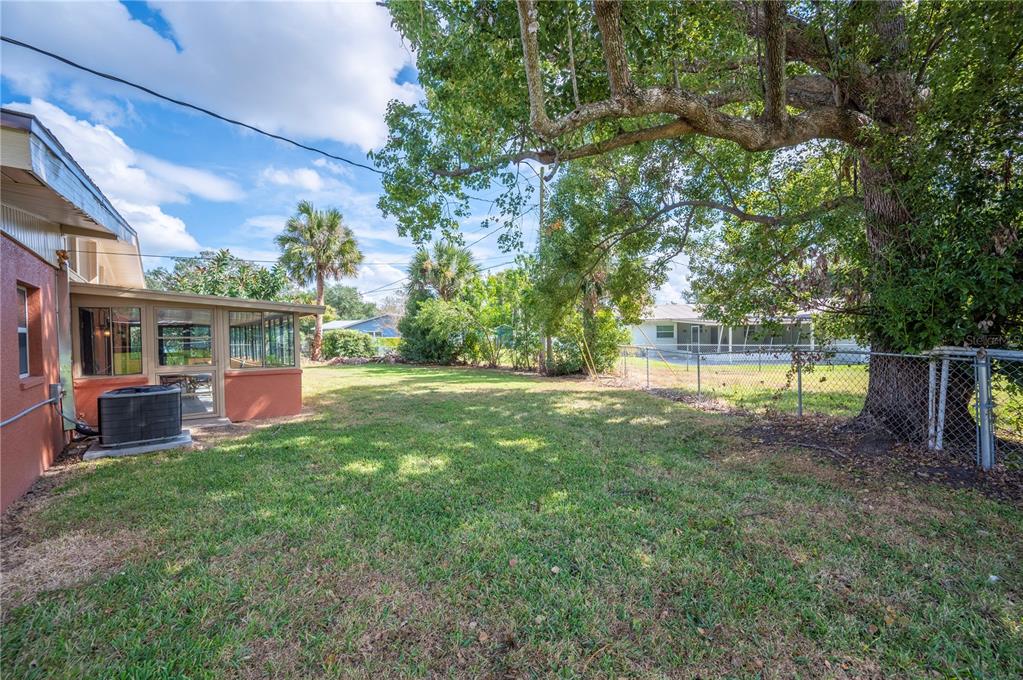2214 Nottingham Road Lakeland, FL 33803 - Photo 38 of 40 a view of backyard with table and chairs and potted plants