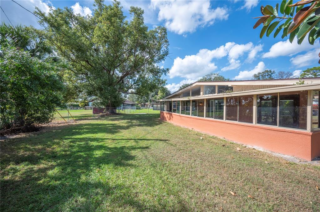2214 Nottingham Road Lakeland, FL 33803 - Photo 39 of 40 a view of a house with a big yard and large trees