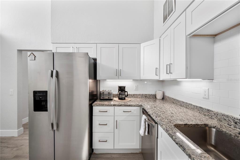2214 Nottingham Road Lakeland, FL 33803 - Photo 10 of 40 a kitchen with granite countertop cabinets and refrigerator