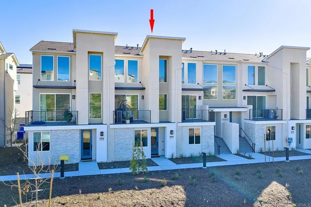 a front view of residential houses with outdoor space