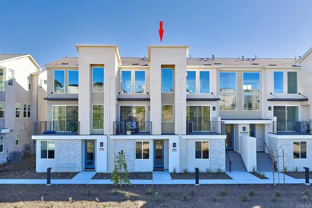 a front view of a residential apartment building with a yard