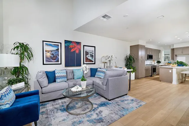 a living room with furniture kitchen and a table