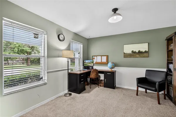 a view of a livingroom with furniture and staircase