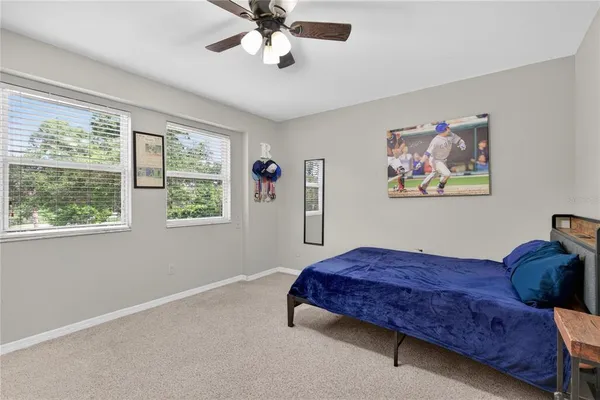 a bedroom with furniture and a flat screen tv