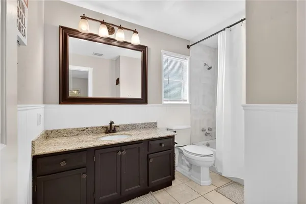 a view of a hallway with closet and a window