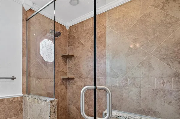 a bathroom with a toilet and a shower