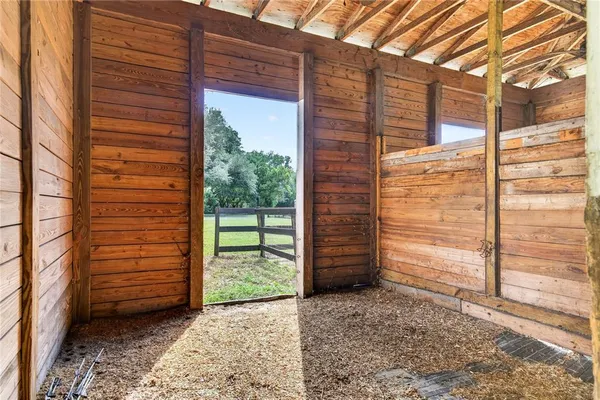 a aerial view of a house with a big yard and large trees