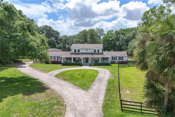 a aerial view of a house with swimming pool and sitting area